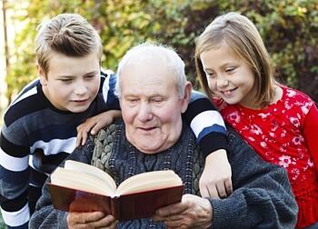 Grandfather reading to his grandkids
