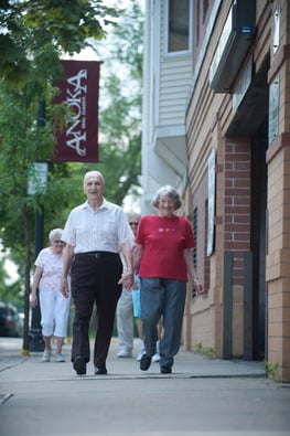 Senior couple walking on sidewalk