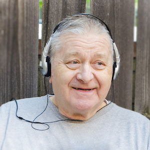 elderly man listening to headphones