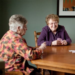 two elderly women playing cards