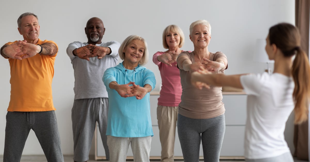 Program director teaching a yoga class at senior living community