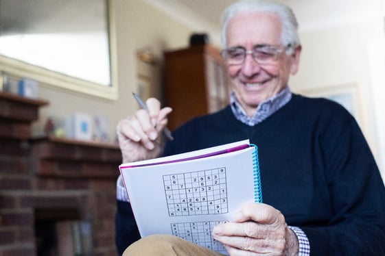 Senior man playing Sudoku 