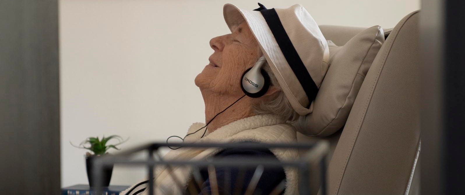 older adult with headphones