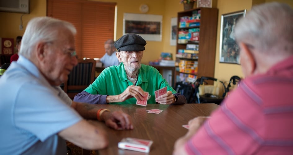 male residents playing cards
